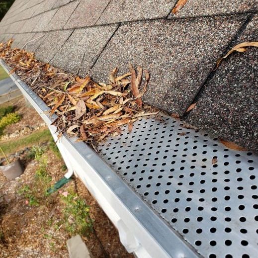 Shows clogged gutters, even with gutter covers you'll need to clean off the debris.